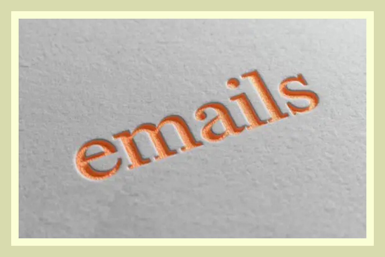 Close-up of the word 'emails' embossed on paper.
